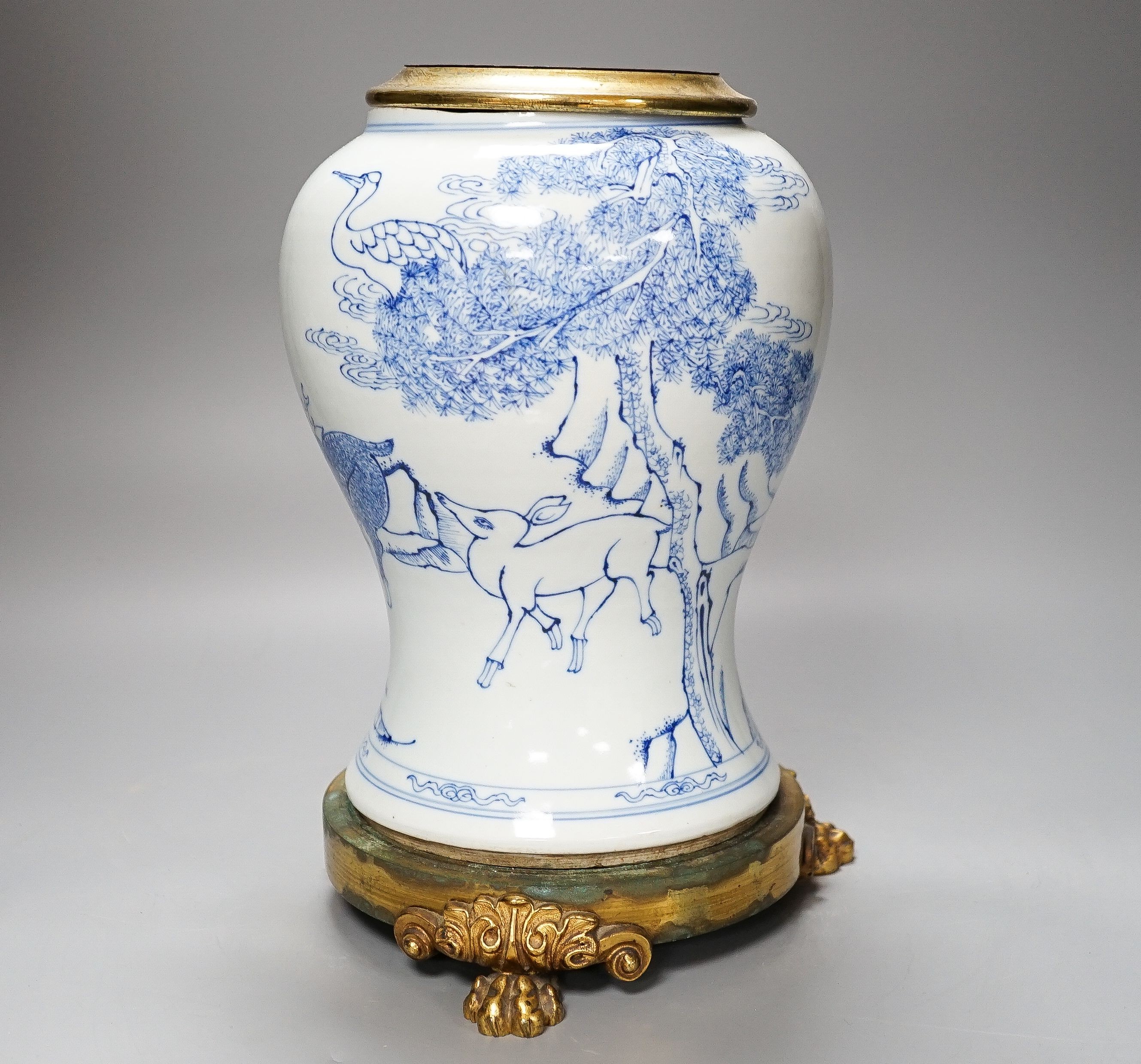 A Chinese blue and white baluster vase, brass mounted 29cm